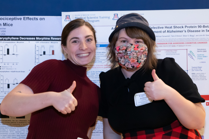 Two Graduate Interdisciplinary Studies students at the annual GIDP showcase