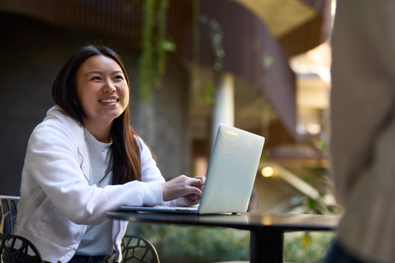 A student with a laptop in the ENR2 building